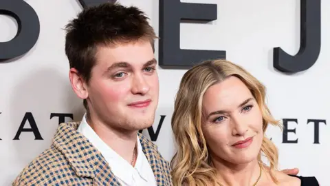 Getty Images Anders and Winslet next to each other looking at a camera out of frame.