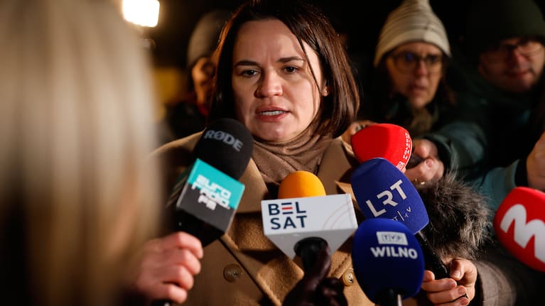 Belarusian opposition leader Sviatlana Tsikhanouskaya speaks to journalists as she waits to meet released Belarusian prisoners