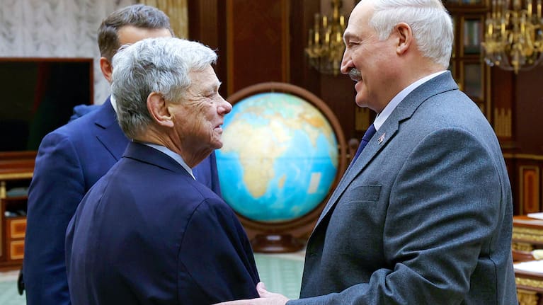 In this photo released by Belarusian presidential press service, Belarusian President Alexander Lukashenko, right, and presidential envoy John Coale shake hands during their meeting in Minsk