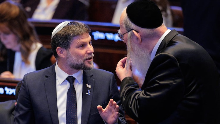 Israel's Finance Minister Bezalel Smotrich, left, stands at the Knesset in Jerusalem on Oct. 13. He is one of two Israeli cabinet members that Canada sanctioned earlier this year. 
