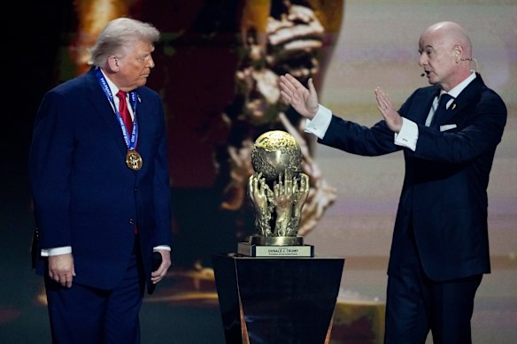 FIFA President Gianni Infantino, right, awards President Donald Trump with the FIFA Peace Prize during the draw for the 2026 soccer World Cup at the Kennedy Centre in Washington.