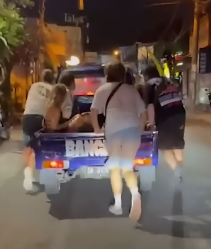 Group of people pushing a vehicle at night, illustrating the snitch who reported Bonnie Blue to cops concept.