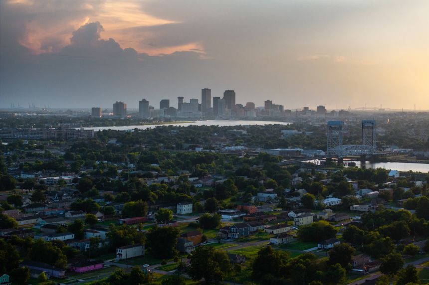 New Orleans' skyline rises August 26 behind rebuilt homes and vacant lots in the Lower Ninth Ward.