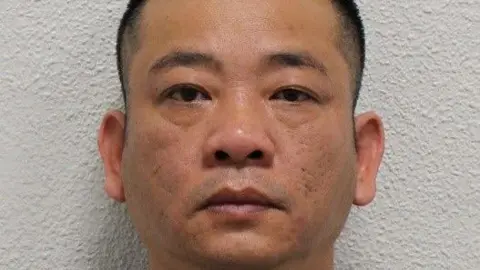 Metropolitan Police Custody image of Hai Nguyen in front of a white wall, with a serious expression and cropped close to his face