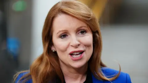 PA Media Ash Regan, who has long red hair, in a close-up shot. She is wearing a blue blazer. 