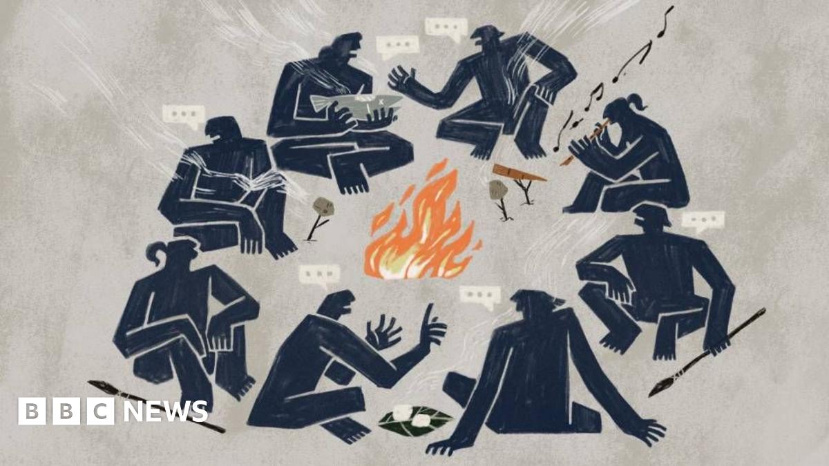 A dinosaur three toed footprint in grey mud, with the footprint filled with water. A trowel lies in the tip of the longest toe.