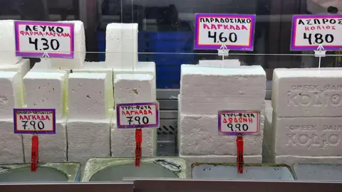 AFP via Getty Images Blocks of feta cheese on sale at a shop in Greece