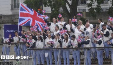 Team GB athletes wave from a boat sailing down the River Seine at the 2024 Paris Olympic Games opening ceremony