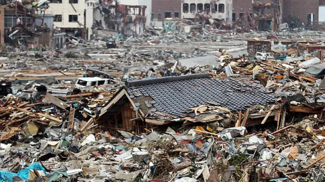 The roof of a house submerged in debris