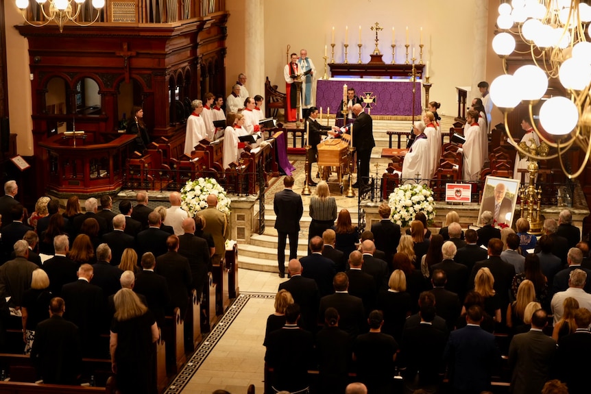 People sat inside a church for graham richardson funeral