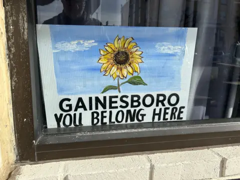 BBC/Mike Wendling A sign with a sunflower motif which reads: "Gainesboro: you belong here"