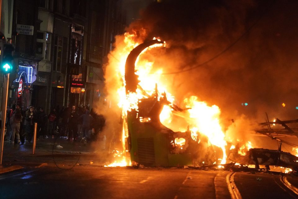 A bus on fire on O’Connell Street in Dublin city centre (PA).