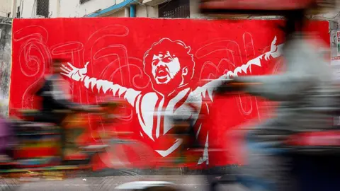 Getty Images Graffiti is painted in Dhaka, Bangladesh, on December 21, 2025, in memory of Osman Hadi, who is killed by an assailant's gunfire. (Photo by Md. Rakibul Hasan Rafiu/NurPhoto via Getty Images)