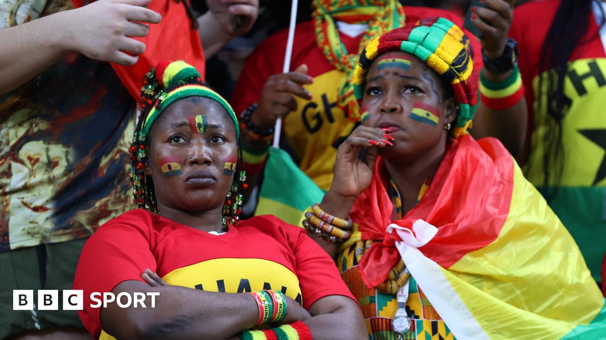 Two Ghana fans watch a World Cup match