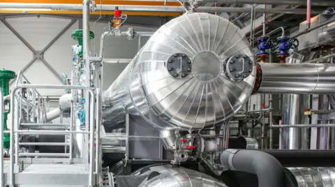 MVV Energie A large, shiny chrome tank with shiny pipework around it. 