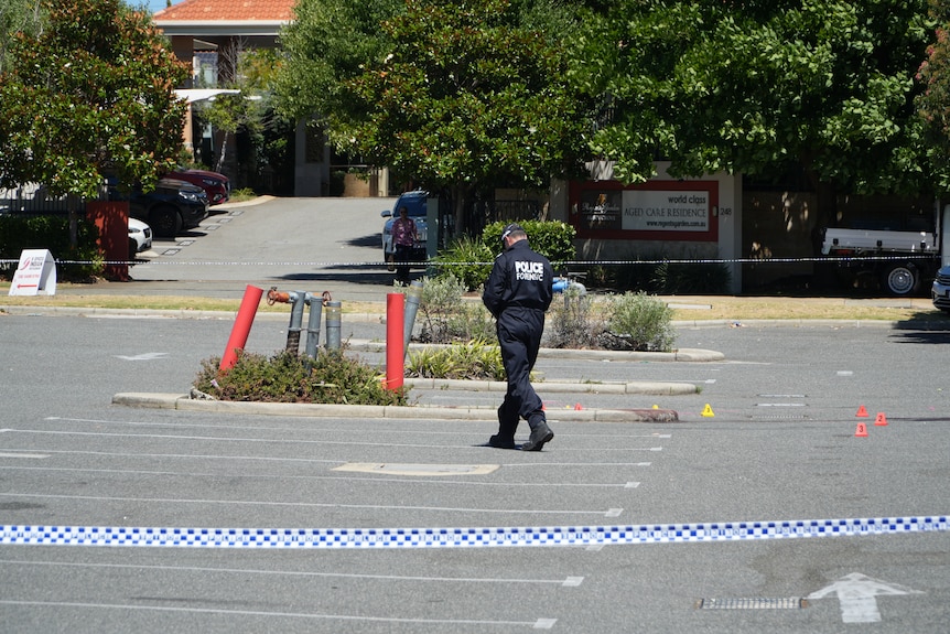 Police search a car park for clues in a murder investigation