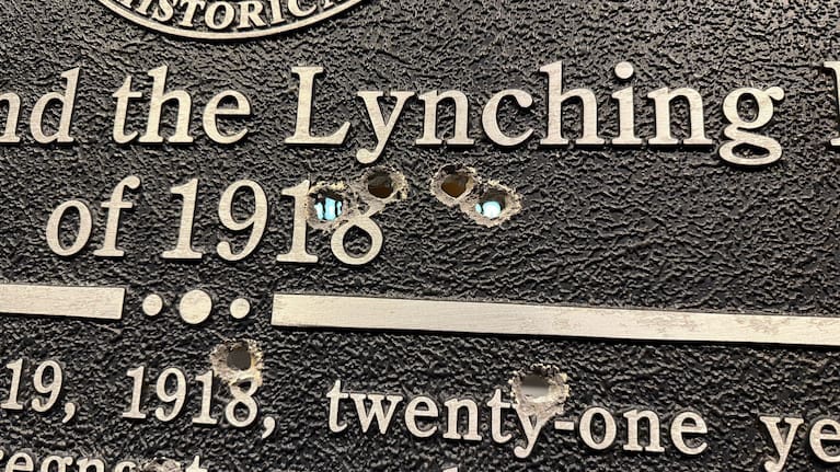 Closeup showing bullet holes in a Georgia Historic Marker memorializing the 1918 lynching of Mary Turner, now on display at the National Center for Civil and Human Rights in Atlanta.