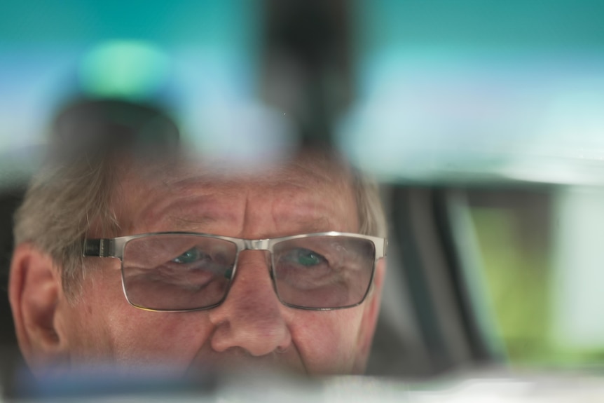 Close up of Terry Ashman's face in a review mirror.