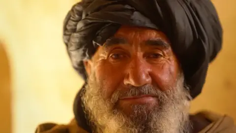 Habibullah looking at the camera