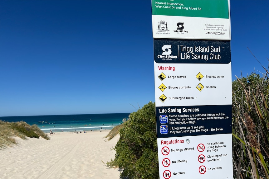 A close up of safety signage at Trigg Beach with the ocean in the background