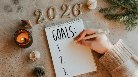 Getty Images Woman's hand writing goals 2026 for New Year. New Year Routine