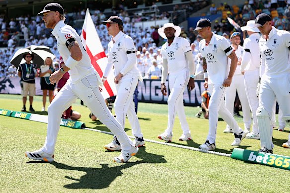 Ben Stokes leads England out.