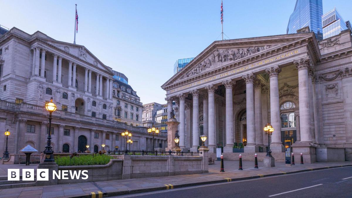 Bank of England building at dusk with street lamps on.