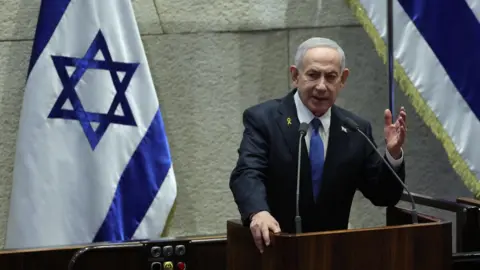 EPA Israeli Prime Minister Benjamin Netanyahu delivers a speech at the opening of the winter session of the Israeli parliament in Jerusalem (20 October 2025)