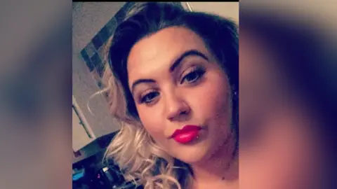 Supplied A selfie of Sophie, who has curled blonde and dark hair, and bright lipstick.