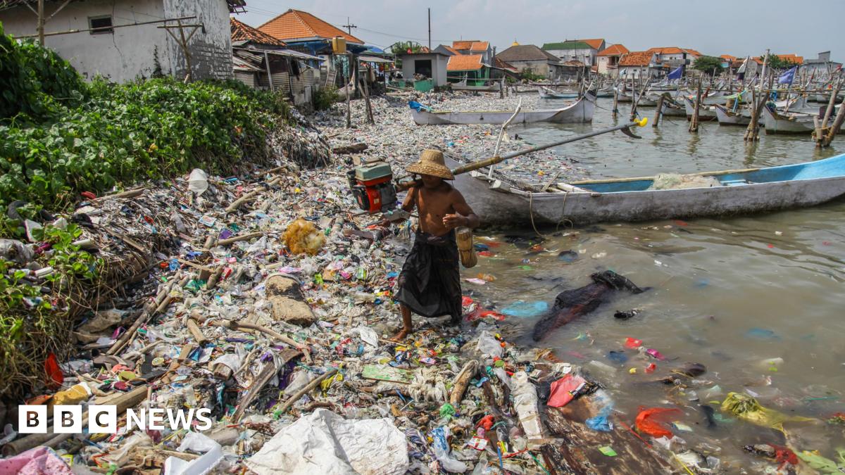A fisherman arrives at the beach full of rubbish that mostly consists of plastics thrown by local residents and brought by sea currents from various locations in the Kwanyar district, Bangkalan, Madura Island of Indonesia