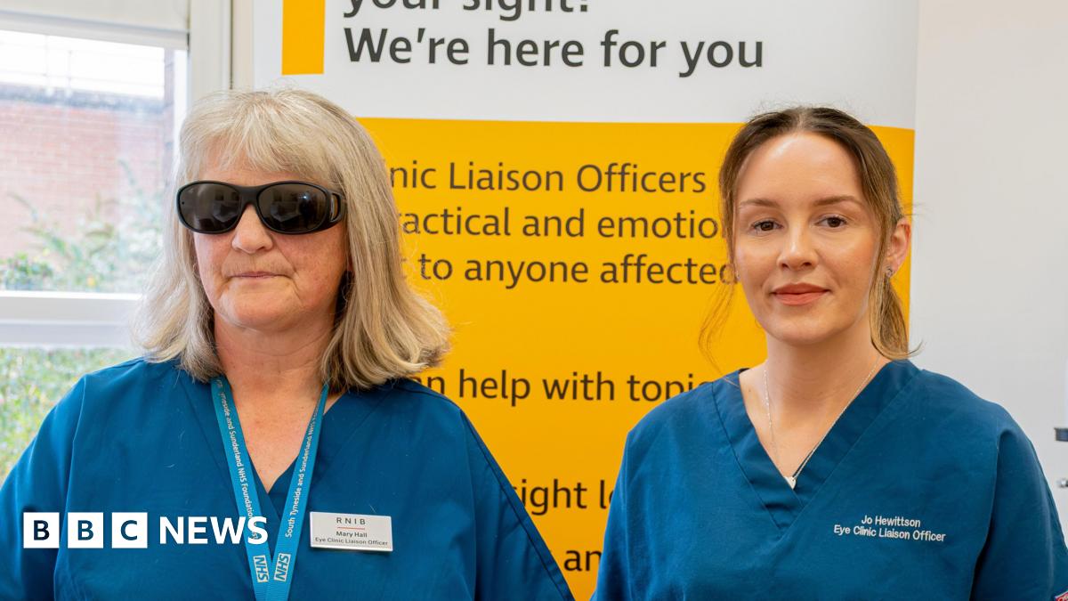 Mary Hall and Jo Hewitson. Ms Hall (left) has shoulder-length blonde hair and is wearing large dark-lensed glasses. Ms Hewitson has hair light hair tied up in a ponytail. Both are wearing blue scrubs.