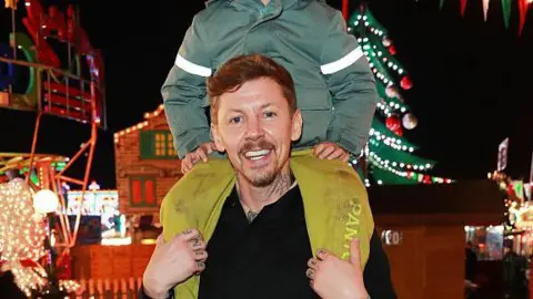 Getty Images Professor Green aka Stephen Manderson with his son Slimane on his shoulders at London's Winter Wonderland this year