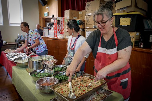 Reverend Natalie Dixon-Monu (right) and volunteers serve Christmas lunch.