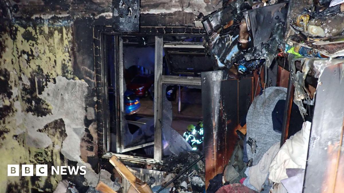 Room devastated by fire showing debris and what looks like a window.