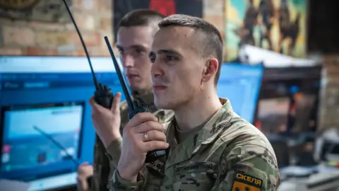 BBC/Matthew Goddard Sasha talks to colleagues in Pokrovsk from his command centre