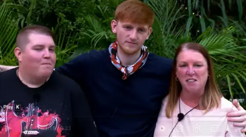 ITV Angry Ginge with his arms around his mum and sister after they were reunited in the jungle in the ITV show