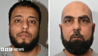 Police custody images of Walid Saadaoui and Amar Hussein, who are both wearing grey t-shirts. Walid Saadaoui has short dark hair and a dark beard. Hussein is bald and has a short dark beard