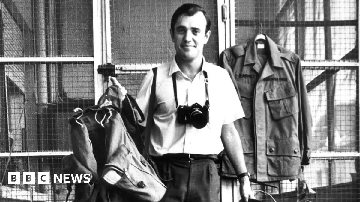 Peter Arnett stands with gear that he carries out in field while covering the Vietnamese army 1963, in Saigon, Vietnam