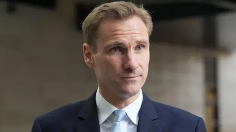 PA Media Shadow home secretary Chris Philp wears a blue suit and tie.