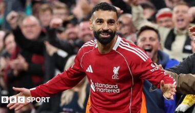 Mohamed Salah celebrates scoring with his arms out wide in front of the Liverpool fans