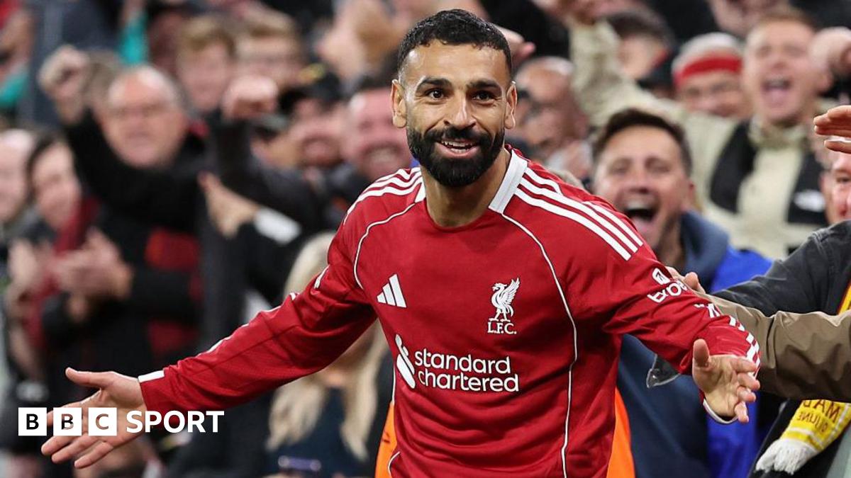 Mohamed Salah celebrates scoring with his arms out wide in front of the Liverpool fans