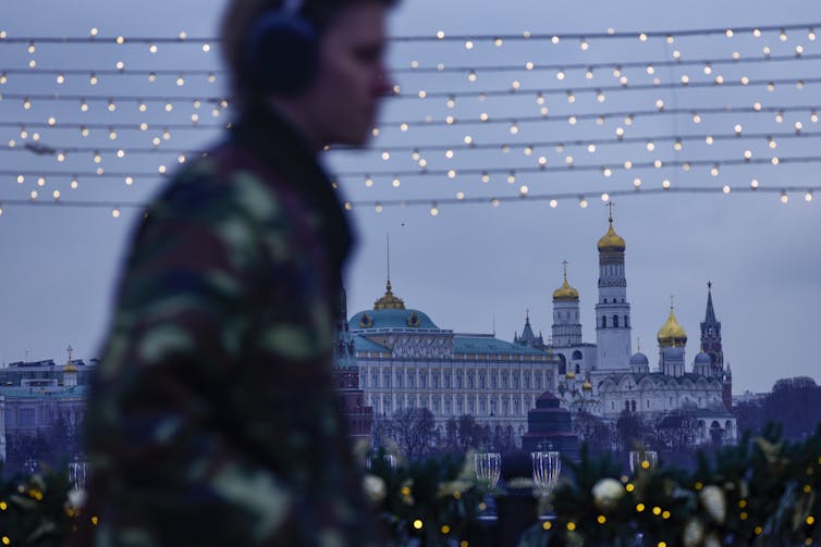 A man walks in front of the Kremlin.