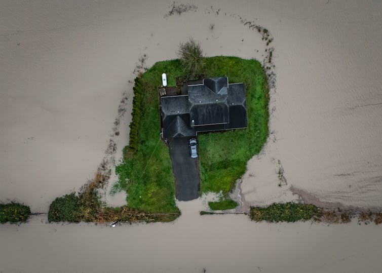 aerial photo of a home surrounded by water