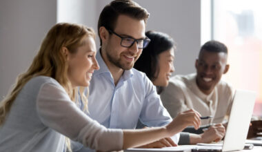 People looking at laptop screens.