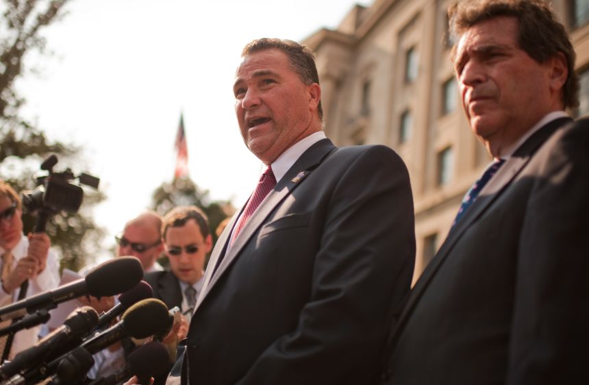 James Riches, left, and attorney Norman Siegel attend a news conference with 9/11 families outside the Justice Department following a meeting between the families and Attorney General Eric Holder.