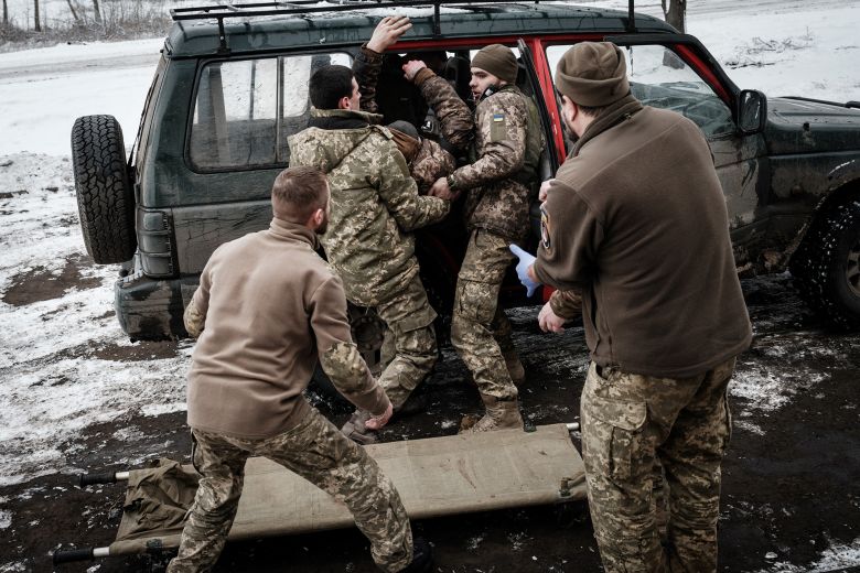 Paramedics receive an injured Ukrainian serviceman who stepped on a mine at a stabilization point near the front line in the Donetsk region on January 29, 2023.