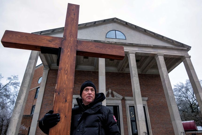 Beazley holds the cross outside Mississippi Boulevard Christian Church in Memphis, Tennessee, ahead of Tyre Nichols' funeral on February 1, 2023. Nichols died after he was repeatedly punched and kicked by Memphis police officers following a traffic stop and brief foot chase.