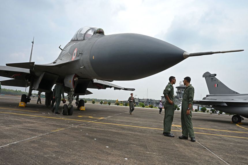 Indian Air Force personnel stand next to a Sukhoi Su-30 fighter jet during a joint exercise with the United States in Kalaikunda, in India's West Bengal state on April 24, 2023.