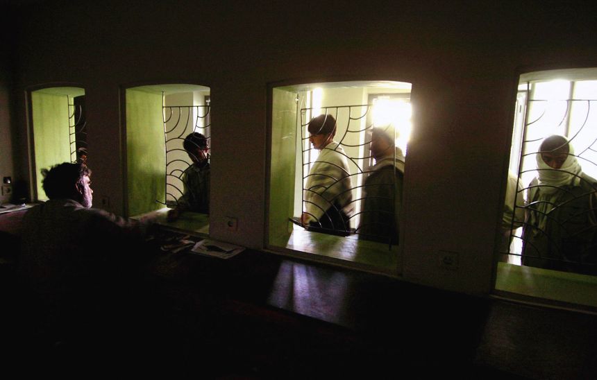 Afghan men queue up to buy tickets at the Ariana Cinema in Kabul.