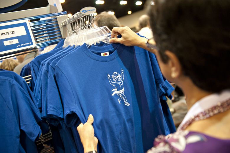 A shareholder looks over a shirt with a caricature of Warren Buffett, chairman of Berkshire Hathaway Inc., in the Brooks booth during the Berkshire Hathaway annual shareholders meeting in 2012.
